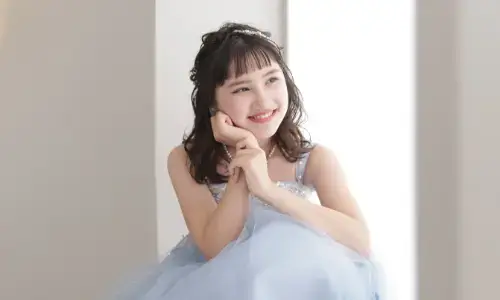 ブルーのドレスで笑顔を見せるティーンのポートレート